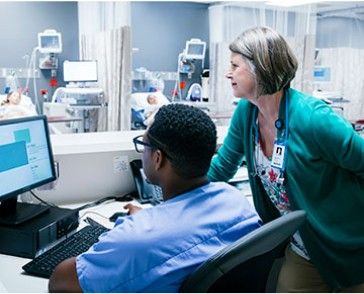 health care providers looking at computer in hospital